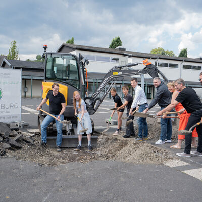 Bild vergr��ern: Spatenstich f�r den neuen Schulhof der Realschule Niederdielfen, v.l. Tillmann Henrich, Fachdienstleiter Zentrales Geb�udemanagement der Gemeinde Wilnsdorf, Sch�lerinnen und Sch�ler der Realschule Niederdielfen, B�rgermeister Hannes Gieseler, Henner Heide, Klimaschutzmanager der Gemeinde Wilnsdorf, Uwe Rinsdorf Schulleiter der Realschule Niederdielfen, Doris Hermann, Planung und Landschaftsarchitektin und Tim Laufenberg, Laufenburg GmbH & Co. KG